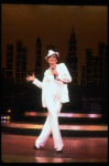 Actress Liza Minnelli wearing a white suit w. a fedora designed by Halston in a scene from the Broadway production of the musical "The Act." (New York)