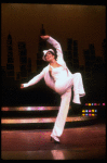 Actress Liza Minnelli wearing a white suit w. a fedora designed by Halston in a scene from the Broadway production of the musical "The Act." (New York)