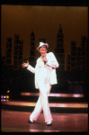Actress Liza Minnelli wearing a white suit w. a fedora designed by Halston in a scene from the Broadway production of the musical "The Act." (New York)