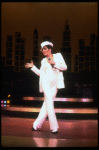 Actress Liza Minnelli wearing a white suit w. a fedora designed by Halston in a scene from the Broadway production of the musical "The Act." (New York)