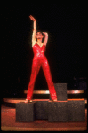 Actress Liza Minnelli in a red-sequined pant suit designed by Halston in a scene from the Broadway production of the musical "The Act." (New York)