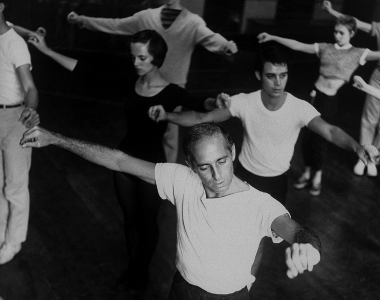 Choreographer Jerome Robbins, in white tshirt directing male and