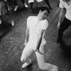 Unidentified male chorus member dancing with others during rehearsals for musical "West Side Story"