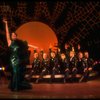 Actress Liza Minnelli in green sequin dress w. dancers seated in a row behind her in a scene from the Broadway production of the musical "The Act." (New York)
