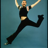Director-choregrapher Michael Bennett striking leaping midair dance pose.
