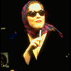Actress/writer Claudia Shear wearing sunglasses and scarf ala Grace Kelly while performing in her one-woman show "Blown Sideways Through Life"