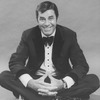 Comic Jerry Lewis sitting crosslegged in a promo shot for the pre-Broadway tour of the musical revue "Hellzapoppin".