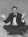 Comic Jerry Lewis sitting crosslegged in a promo shot for the pre-Broadway tour of the musical revue "Hellzapoppin".