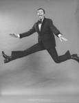 Comic Jerry Lewis mugging while flying in a promo shot for the pre-Broadway tour of the musical revue "Hellzapoppin".