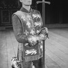 Actor Kevin Kline kneeling with a sword in a scene from the NY Shakespeare Festival Central Park production of the play "Henry V"