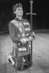 Actor Kevin Kline kneeling with a sword in a scene from the NY Shakespeare Festival Central Park production of the play "Henry V"