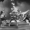 Actor Kevin Kline wielding a sword (C) in a scene from the NY Shakespeare Festival Central Park production of the play "Henry V"