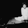 Leslie Uggams singing atop a piano in a scene from the Broadway production of the musical "Jerry's Girls"