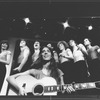 Composer Elizabeth Swados playing guitar with the cast in a scene from the off-Broadway production of the musical "Nightclub Cantata"