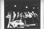 Composer Elizabeth Swados playing guitar with the cast in a scene from the off-Broadway production of the musical "Nightclub Cantata"