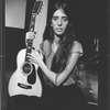 Composer Elizabeth Swados holding her guitar in a scene from the off-Broadway production of the musical "Nightclub Cantata"