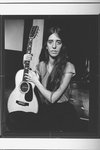 Composer Elizabeth Swados holding her guitar in a scene from the off-Broadway production of the musical "Nightclub Cantata"