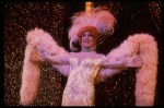 George Hearn in drag in a white costume w. a feather boa in a scene from the Broadway musical "La Cage Aux Folles." (New York)