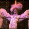 George Hearn in drag in a white costume w. a feather boa in a scene from the Broadway musical "La Cage Aux Folles." (New York)