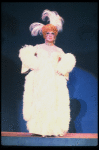 George Hearn in drag in a white costume w. a feather boa in a scene from the Broadway musical "La Cage Aux Folles." (New York)