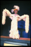 George Hearn in drag in a white costume w. a feather boa in a scene from the Broadway musical "La Cage Aux Folles." (New York)