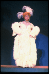 George Hearn in drag in a white costume w. a feather boa in a scene from the Broadway musical "La Cage Aux Folles." (New York)