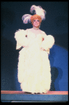 George Hearn in drag in a white costume w. a feather boa in a scene from the Broadway musical "La Cage Aux Folles." (New York)