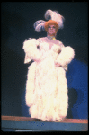 George Hearn in drag in a white costume w. a feather boa in a scene from the Broadway musical "La Cage Aux Folles." (New York)