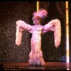 George Hearn in drag in a white costume w. a feather boa in a scene from the Broadway musical "La Cage Aux Folles." (New York)