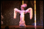 George Hearn in drag in a white costume w. a feather boa in a scene from the Broadway musical "La Cage Aux Folles." (New York)
