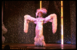 George Hearn in drag in a white costume w. a feather boa in a scene from the Broadway musical "La Cage Aux Folles." (New York)