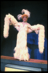 George Hearn in drag in a white costume w. a feather boa in a scene from the Broadway musical "La Cage Aux Folles." (New York)