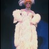 George Hearn in drag in a white costume w. a feather boa in a scene from the Broadway musical "La Cage Aux Folles." (New York)