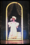 George Hearn in drag in a white costume w. a feather boa in a scene from the Broadway musical "La Cage Aux Folles." (New York)