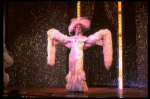 George Hearn in drag in a white costume w. a feather boa in a scene from the Broadway musical "La Cage Aux Folles." (New York)
