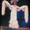 George Hearn in drag in a white costume w. a feather boa in a scene from the Broadway musical "La Cage Aux Folles." (New York)