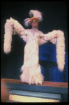 George Hearn in drag in a white costume w. a feather boa in a scene from the Broadway musical "La Cage Aux Folles." (New York)