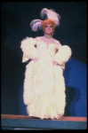 George Hearn in drag in a white costume w. a feather boa in a scene from the Broadway musical "La Cage Aux Folles." (New York)