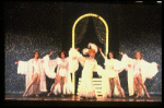 George Hearn (C) in drag in a white costume w. a feather boa in a scene from the Broadway musical "La Cage Aux Folles." (New York)