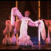 George Hearn (C) in drag in a white costume w. a feather boa in a scene from the Broadway musical "La Cage Aux Folles." (New York)