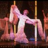 George Hearn (C) in drag in a white costume w. a feather boa in a scene from the Broadway musical "La Cage Aux Folles." (New York)