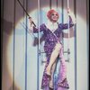 George Hearn (C, in a purple gown) on a swing in a scene from the Broadway musical "La Cage Aux Folles." (New York)