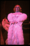 George Hearn in drag in a white costume w. a feather boa in a scene from the Broadway musical "La Cage Aux Folles." (New York)