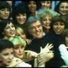 Director/choreographer Gower Champion surrounded by chorus girls during a rehearsal for the Broadway production of the musical "42nd Street." (New York)