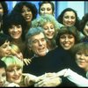 Director/choreographer Gower Champion surrounded by chorus girls during a rehearsal for the Broadway production of the musical "42nd Street." (New York)