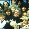 Director/choreographer Gower Champion surrounded by chorus girls during a rehearsal for the Broadway production of the musical "42nd Street." (New York)