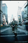 A castmember from the Broadway production of the musical "Pacific Overtures" posing in the middle of Times Square to advertise the show. (New York)