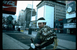 A castmember from the Broadway production of the musical "Pacific Overtures" posing in the middle of Times Square to advertise the show. (New York)