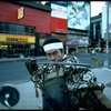 A castmember from the Broadway production of the musical "Pacific Overtures" posing in the middle of Times Square to advertise the show. (New York)