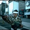 A castmember from the Broadway production of the musical "Pacific Overtures" posing in the middle of Times Square to advertise the show. (New York)